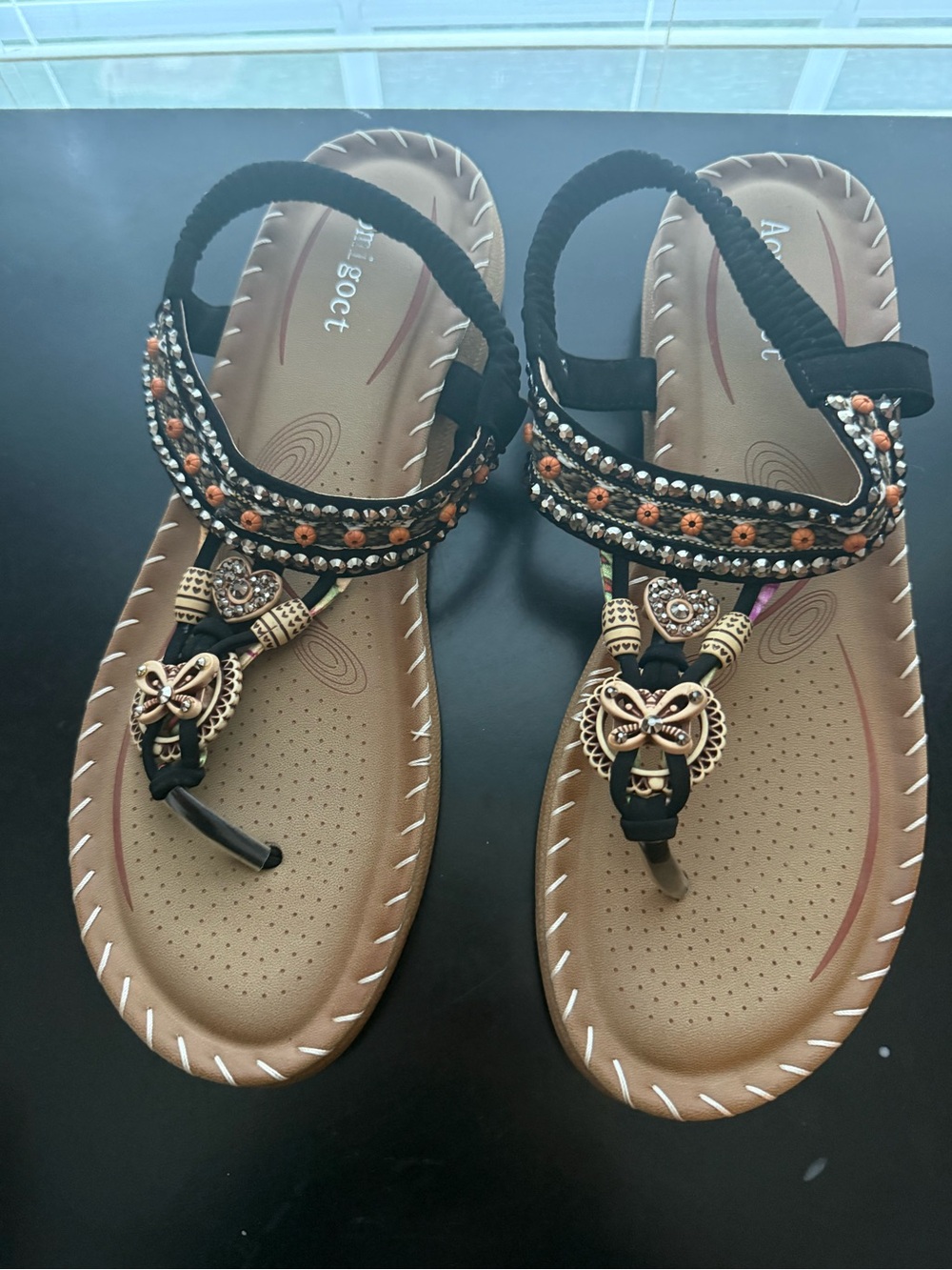 Embellished Black and Tan T-Strap Sandals with Gold Accents